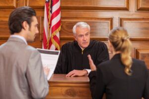A Miami attorney questions evidence collection, handling, and use as a judge looks on. Criminal defense lawyers can ask the court to throw out any evidence gathered unlawfully.